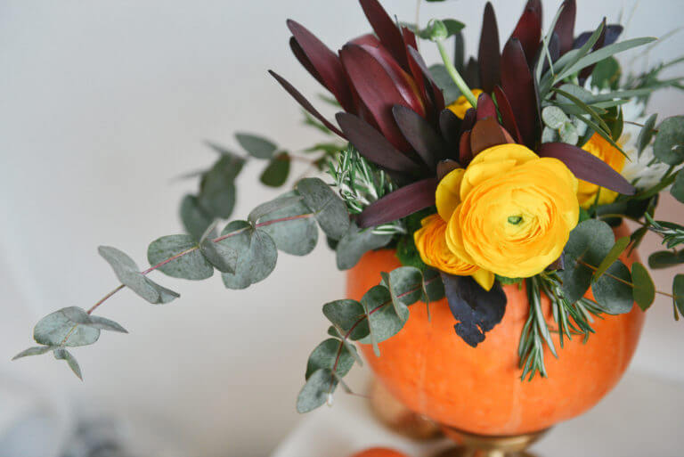 fall flower arrangement in a pumpkin vase