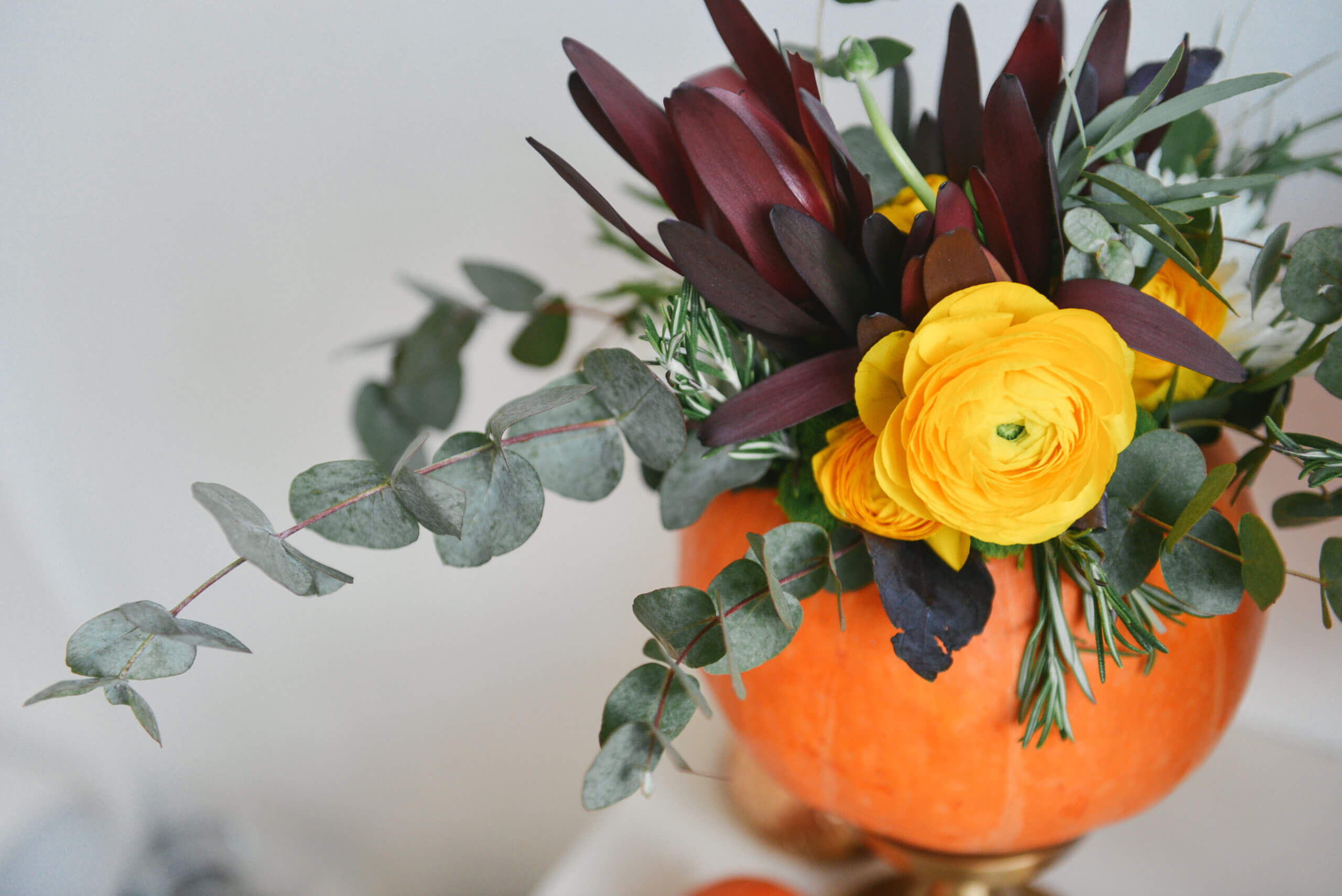 fall flower arrangement in a pumpkin vase